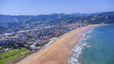 Aerial view of zarautz, gipuzkoa, showcasing the urban area meeting a golden sandy beach, with