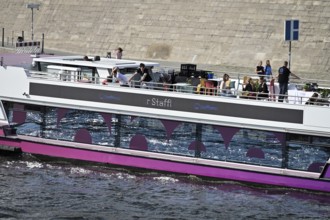 The media ship The Pionieer One sails on the Spree near the Kapelleufer