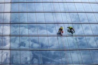 Detroit, Michigan - Window washers at the 25-story Residences Water Square luxury apartment