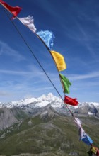 Böses Weibl summit with colourful prayer flags, view of picturesque mountain landscape with