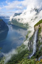 Gjerdefossen waterfall, at Ørnesvingen viewpoint, atmospheric clouds over the fjord in the morning
