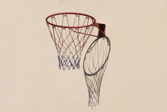 Basketball hoop with shadow cast on a white wall