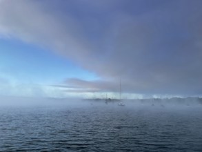 Sailing boats on Lake Starnberg with fog, Bavaria, Germany