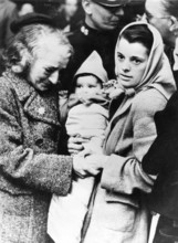 Soviet refugees, 1920, An older and a younger couple holding a baby wrapped in blankets in an