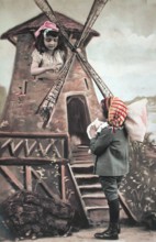 Children's windmill, miller, ca. 1910, Two children play a scene at a windmill in colourful