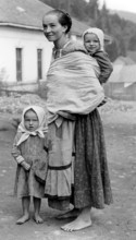 Farmer's woman and children, 1930s, A woman with two children in traditional dress on a dusty road,