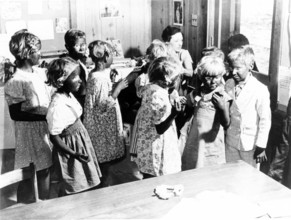 Children made up black face, 1920s, A group of children in a room, apparently for a class reunion