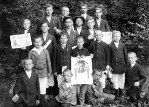 Young sports group with their awards, 1920s, boys in fine clothes, some with certificates, posing