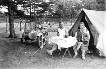Camping family, 1930s, family camping next to a tent and motorbike, relaxed outdoor atmosphere,
