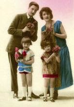 Family with flowers, 1930s, Family portrait with flowers in colourful clothes, smiling and posing,
