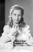 Praying girl, 1930s, A young girl in nostalgic clothing, dreamy and elegant, looks at the viewer,