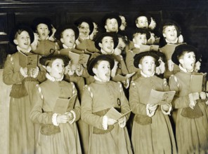 Traditional boys' choir, 1930s, group of children in historical costumes singing together in a