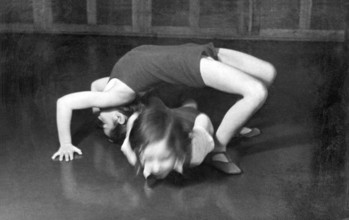 Children practising acrobatics, 1920s, Two children performing a gymnastic exercise on a floor,