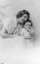 Mother with child, 1930s, Woman and small child sitting next to each other and laughing in a studio