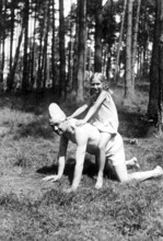 Girl riding on her father's back, 1930s, A girl rides happily on a man kneeling on all fours in the
