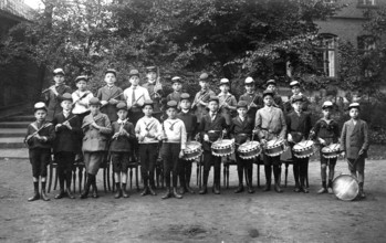 Boys' orchestra, 1920s, A group of boys in uniforms with drums in a schoolyard, Historical photo