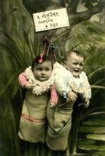 2 Babies in a sack, 1920, Two babies in sacks, hanging with a whimsical sign 'for sale', historical