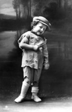 Torn boy with pipe, 1920, Boy in torn clothes with pipe, standing in front of a picturesque