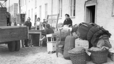 Refugees from the GDR loading lorries with furniture, 1960s, people standing next to furniture and