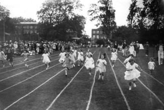 Many girls on race track, 1910, A group of children running on a race track in a friendly