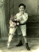 Boy with school cone, 1930s, A little boy in a suit with a large, decorative bouquet of flowers,