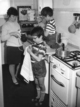 Mother and sons drying dishes, housework, education, 1960s, mother and two children busy in the