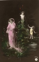 Woman and girl in front of a fountain, 1910s, Woman with pink veil and children in a flowery pond,