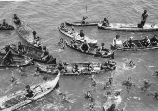 Children in the water between catamarans, Asia 1930s, Group of people in small boats and swimming