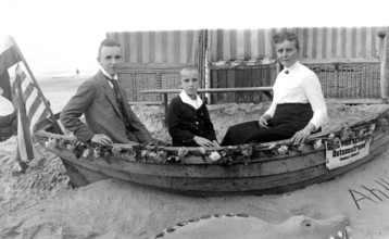 Family in a boat, beach, Baltic Sea, 1930s, Family sitting in a small boat on the beach, Historical