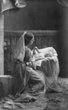 Mother with child, 1920s, woman in historical dress looking at child in hay, heavenly scenery,