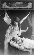 Angel at a child's bedside, 1920s, An angel watches over a sleeping child in a bed, Historical