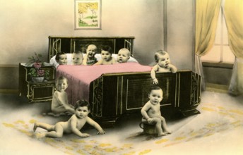 Nine babies in a bed, 1920s, Several babies crawling curiously around a large bed in a room,