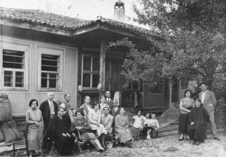 Family photo, 1920s, Group of people in front of a traditional house on the veranda, Historical