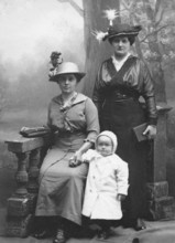 Two woman with a child, 1920s, Two elegantly dressed woman with a small child in a studio,
