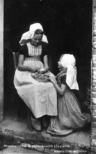 Peeling potatoes, 1920s, Two woman in traditional Seeland traditional costume peeling potatoes on