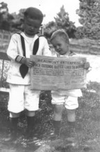 Two children reading a newspaper, First World War, 1910s, Two children in sailor suits reading a