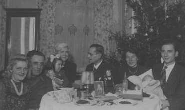 Christmas party, 1930s, Christmas party with a family around a set table with presents and a