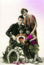 Horseshoe lucky family, 1910, A family poses together with lucky symbols such as horseshoe and