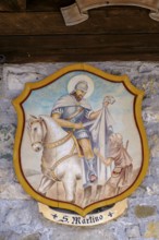 St Martin sharing his cloak at a farmhouse, Sappada, Plodn, Carnic Alps, Julian Friuli, Italy