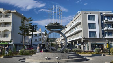 Modern sculpture in an urban setting with surrounding modern buildings, Sculpture The Traveller,