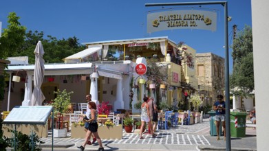 Lively street scene with people at a café in sunny weather, Platia Diagora, Kos Town, Kos,