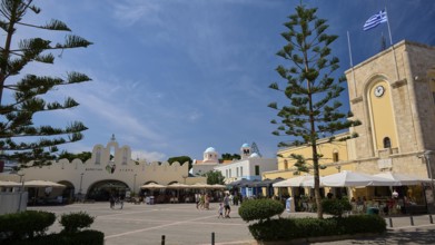 Public square with cafés and striking architectural elements under a blue sky, Eleftherias Square,