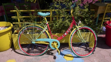 Colourful bicycle with 'i love kos' sign on a cobbled street, sunny atmosphere, Platia Diagora, Kos