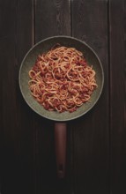 Spaghetti bolognese, in a frying pan, top view, homemade, no people