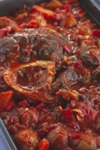 Ossobuco stew with vegetables, knuckle on the bone with new potatoes, in tomato sauce, homemade,