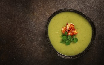 Pea cream soup, with shrimp, green soup, homemade, top view, no people