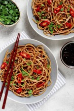 Udon noodles, with shimeji mushrooms, vegetables, in sauce, with sesame seeds, green onions, Asian