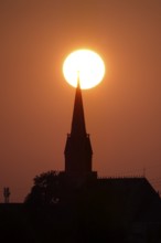 Sun in the evening in June, church tower, Germany