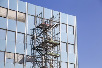 Steel scaffolding on the large glass façade of an office building