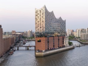 The Elbphilharmonie concert hall in Hamburg is reflected in the glass design above the historic